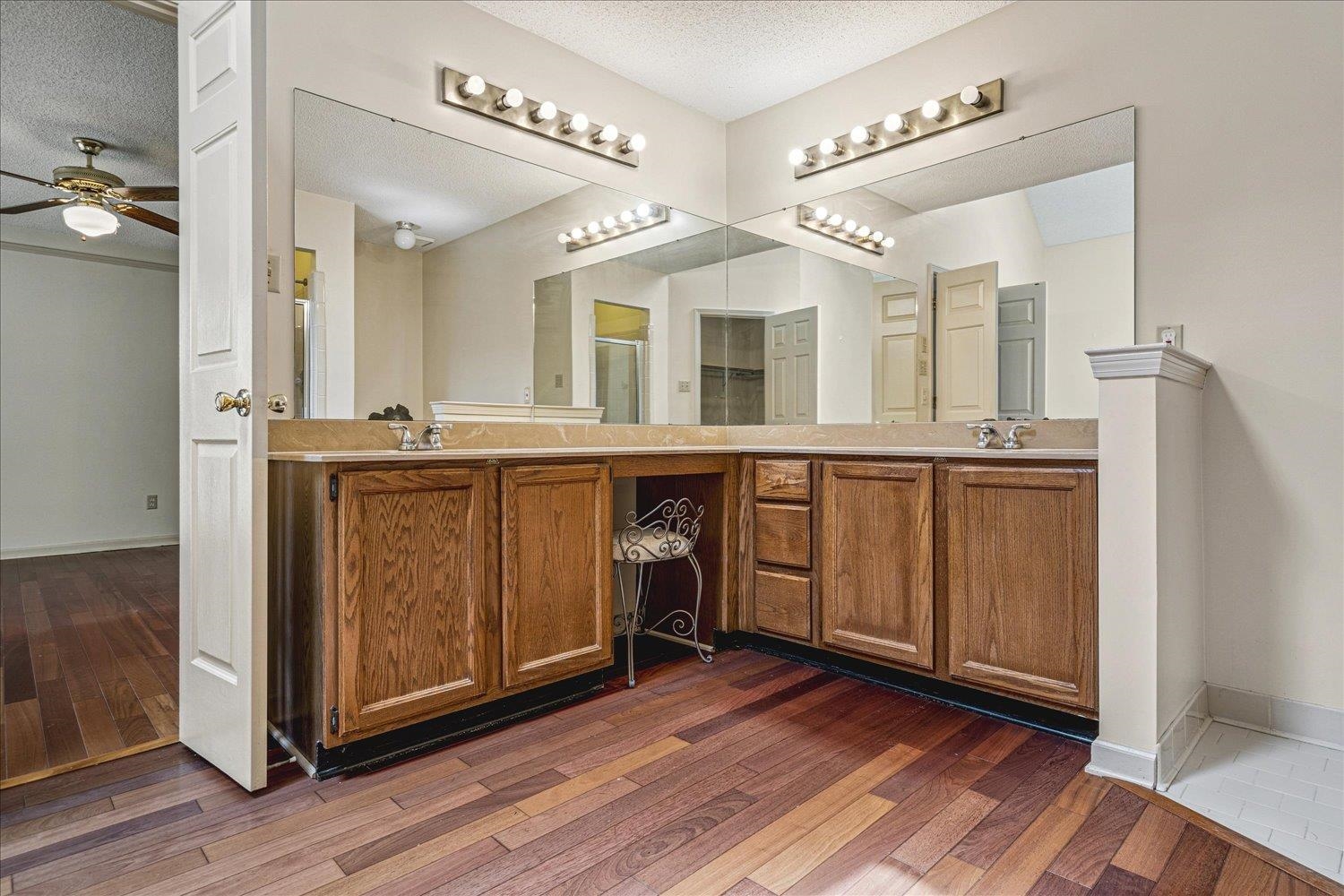 8529 Buckhurst Road Memphis, TN 38016 - Photo 22 of 36 Full bath featuring double vanity, dark wood finished floors, a ceiling fan, and a textured ceiling