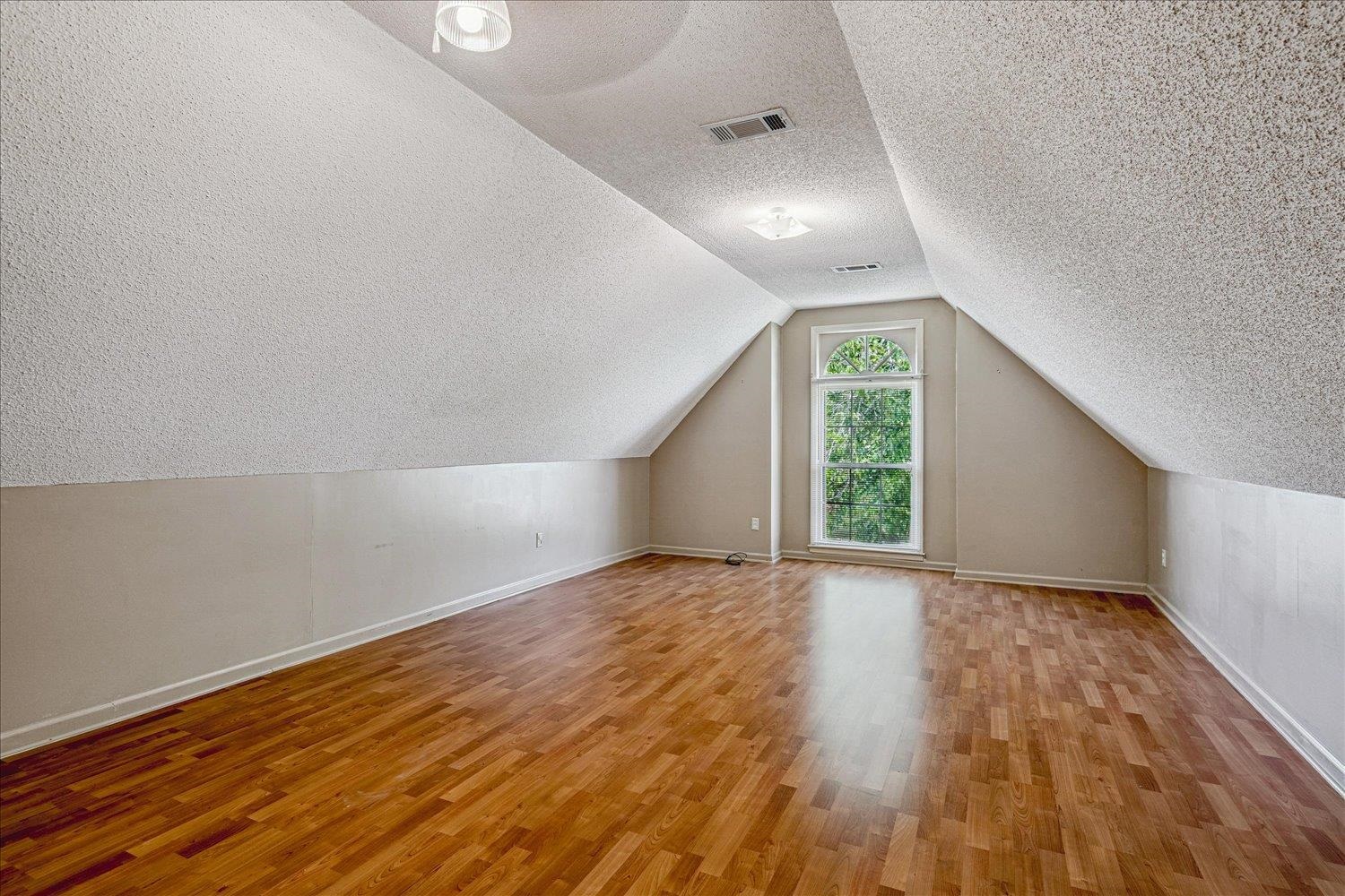 8529 Buckhurst Road Memphis, TN 38016 - Photo 30 of 36 Bonus room featuring light wood-type flooring and a textured ceiling