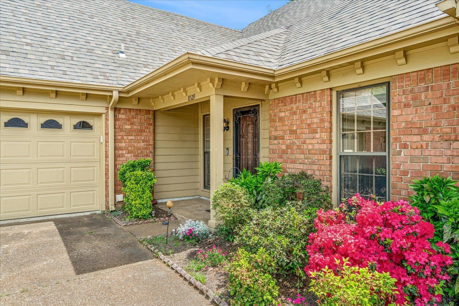 8529 Buckhurst Road Memphis, TN 38016 - Photo 3 of 36 Entrance to property with roof with shingles, brick siding, concrete driveway, and an attached garage