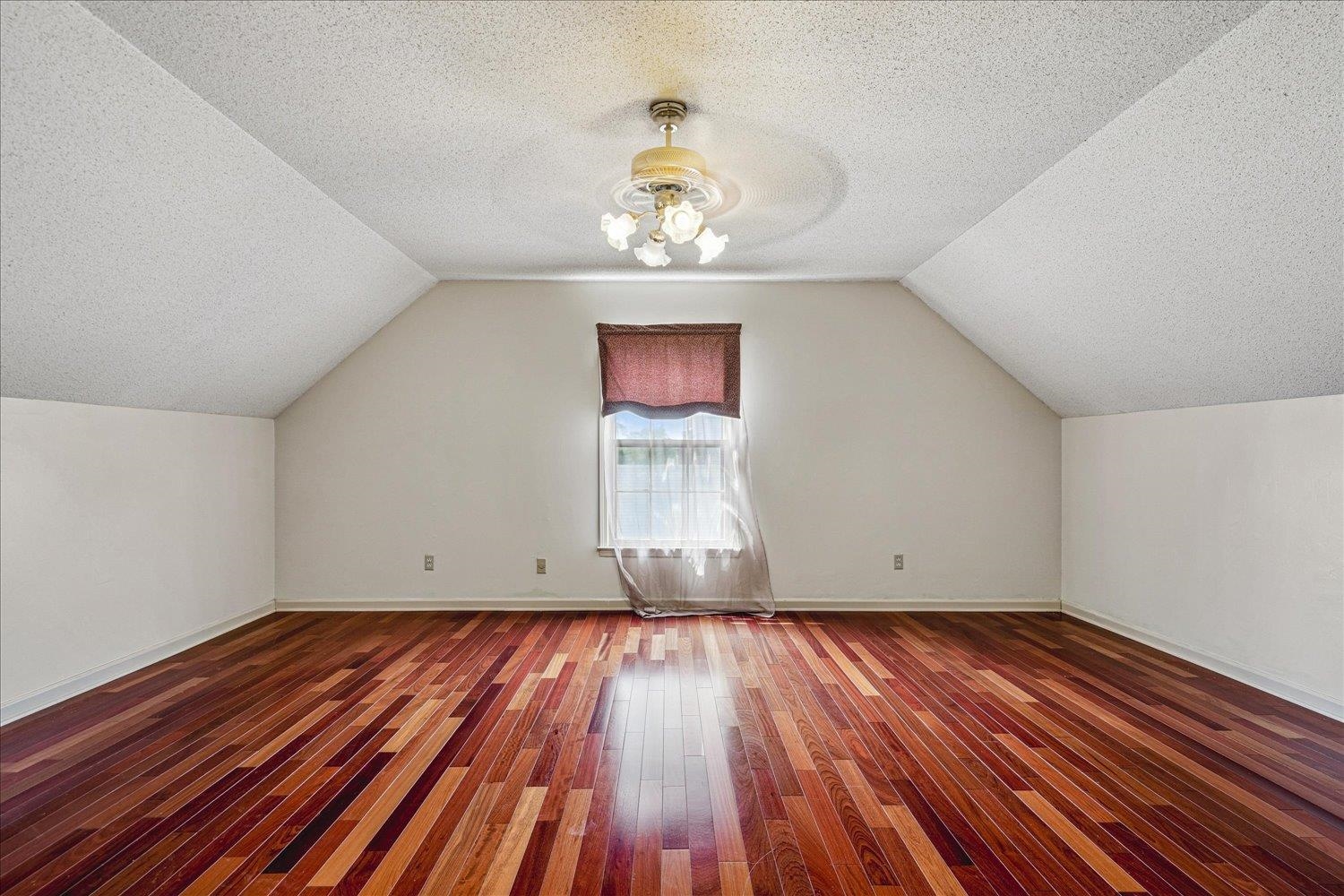8529 Buckhurst Road Memphis, TN 38016 - Photo 31 of 36 Additional living space featuring a textured ceiling, hardwood / wood-style flooring, and a ceiling fan