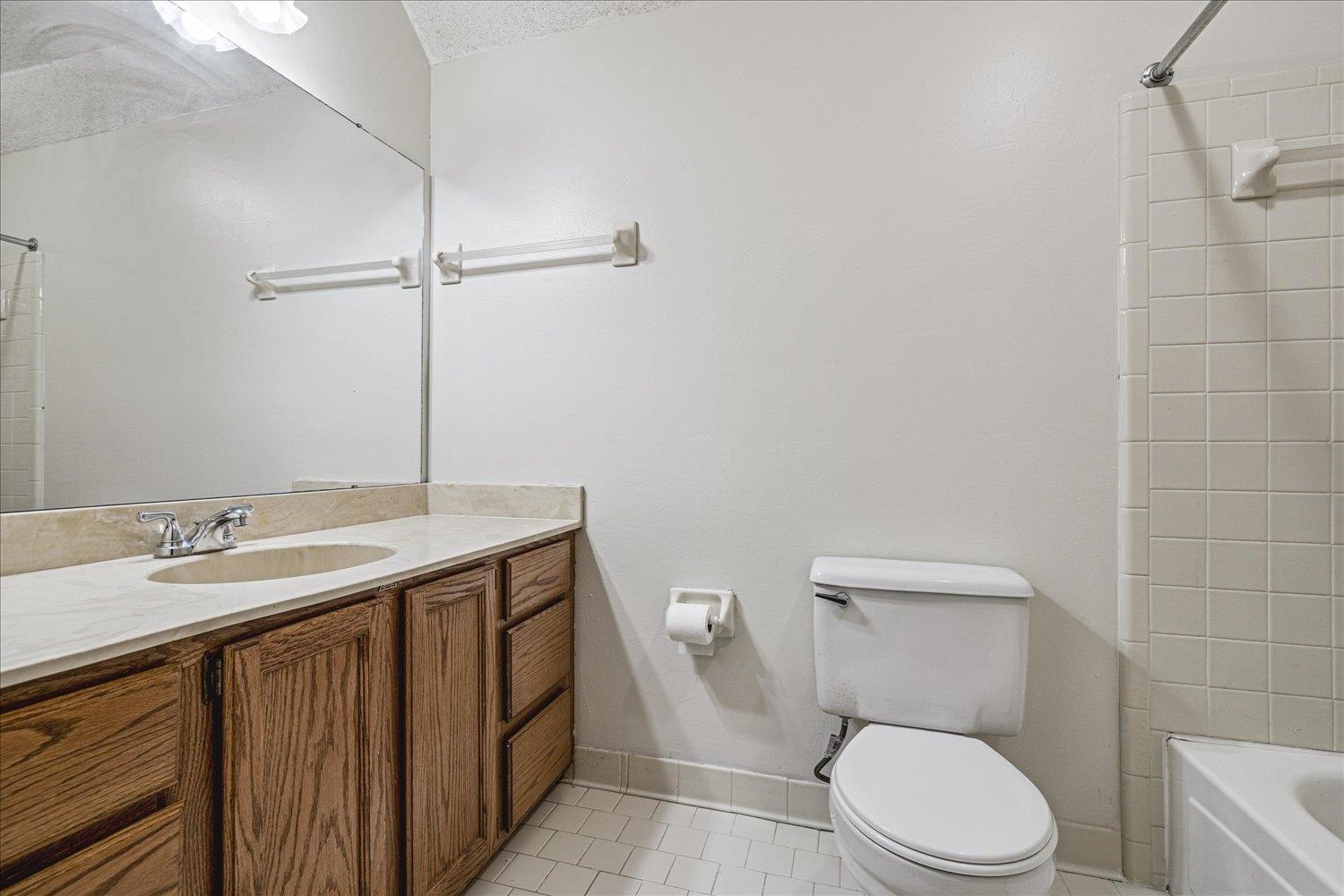8529 Buckhurst Road Memphis, TN 38016 - Photo 32 of 36 Full bathroom featuring light tile patterned floors, vanity, and washtub / shower combination