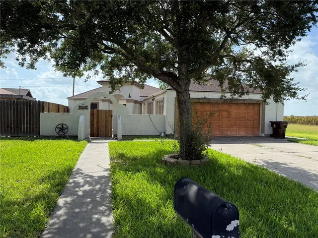 a front view of house with yard and green space