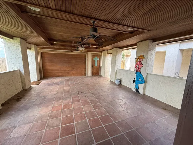 a view of a livingroom with wooden floor and windows