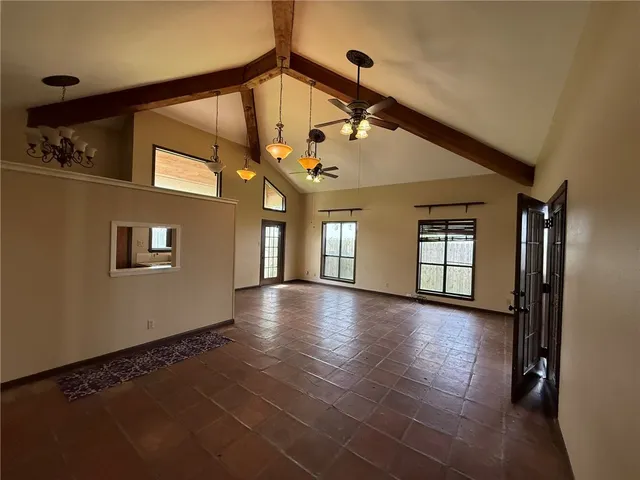 a view of a livingroom with a ceiling fan and window