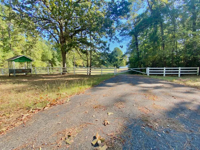 a view of yard with swimming pool and trees