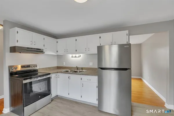 a kitchen with a white cabinets and white appliances