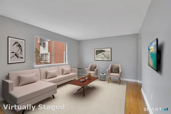 a living room with furniture wooden floor and window