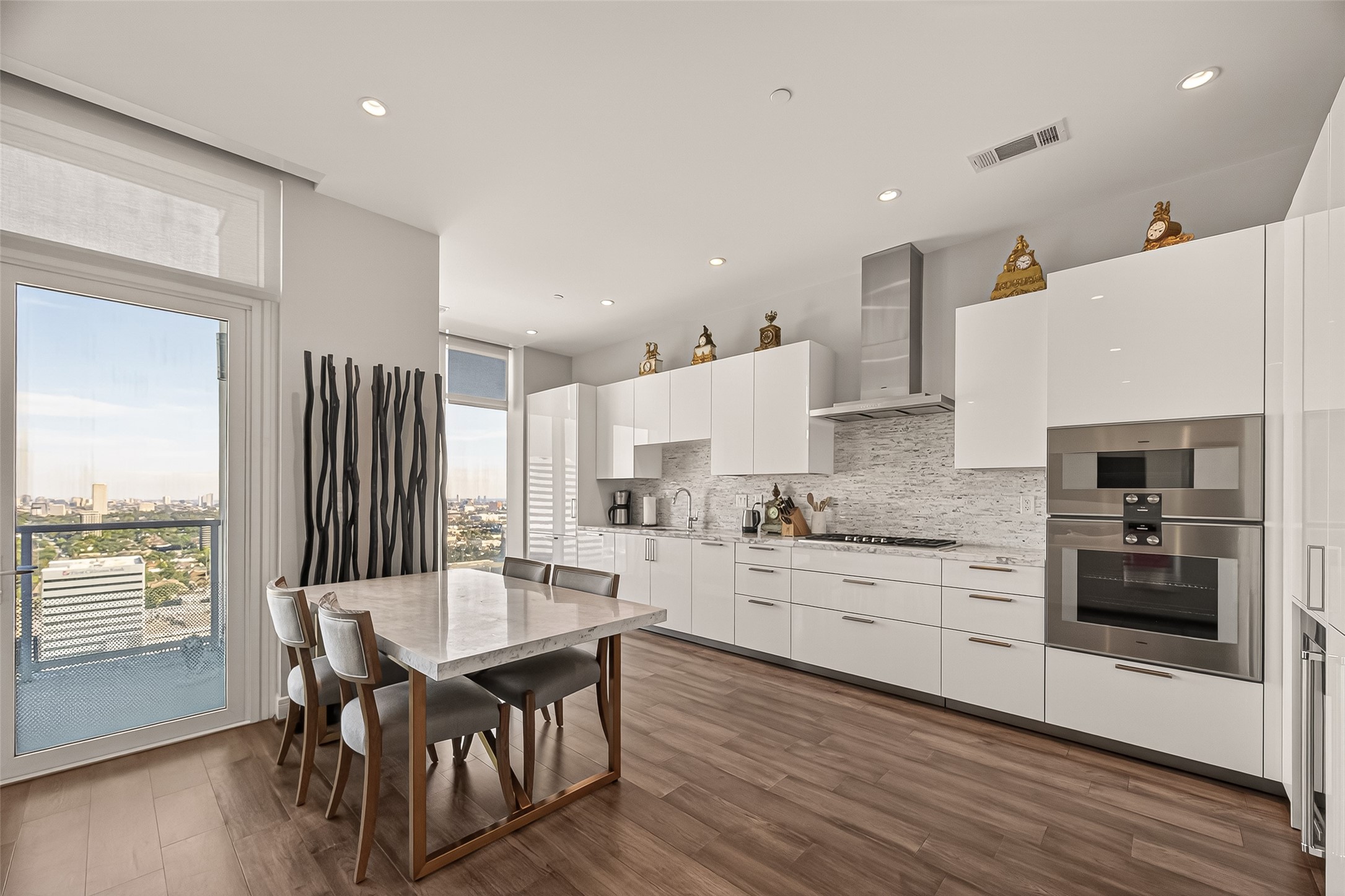 4521 San Felipe Street, Unit 2602 Houston, TX 77027 - Photo 6 of 41 a kitchen with stainless steel appliances granite countertop a stove top oven a sink dishwasher and a refrigerator with wooden floor