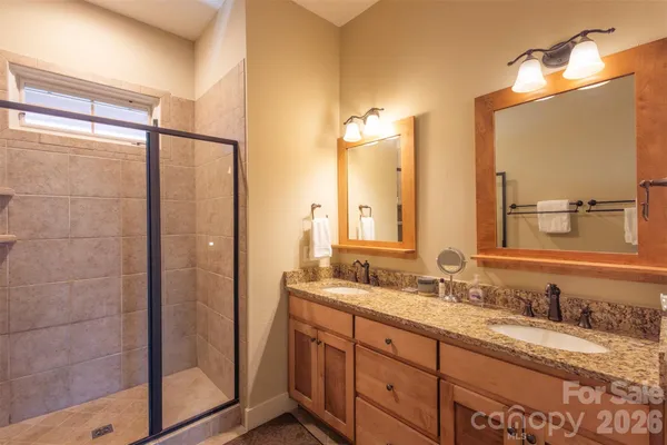 a bathroom with double vanity sinks and a mirror