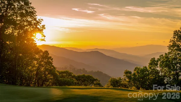 a view of a couches and a table in the balcony