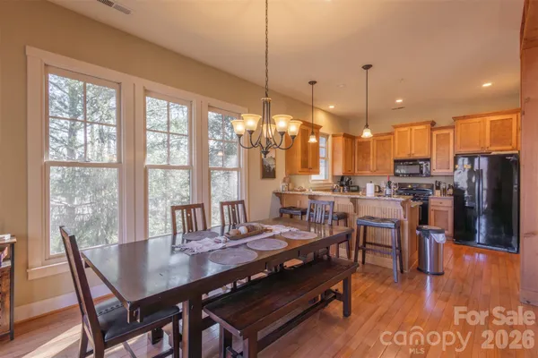 a view of a dining room with furniture window and wooden floor