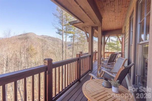 a view of a balcony with chair and wooden floor