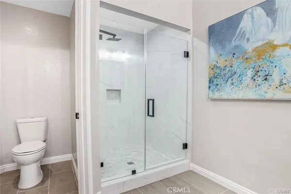 a bathroom with a shower and toilet