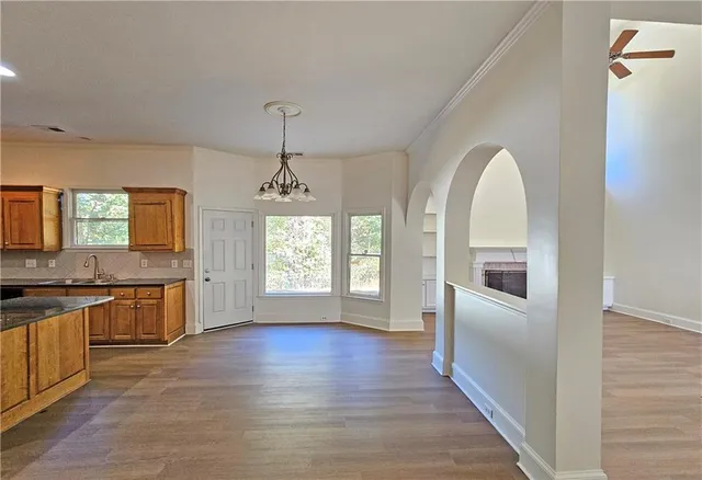 a view of a kitchen with a sink dishwasher and wooden floor