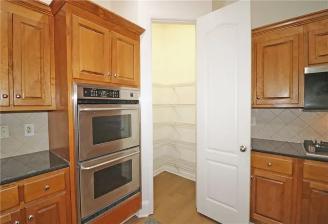 a kitchen with granite countertop cabinets stainless steel appliances and counter space