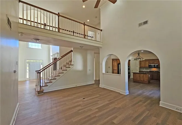 a view of entryway and hall with wooden floor