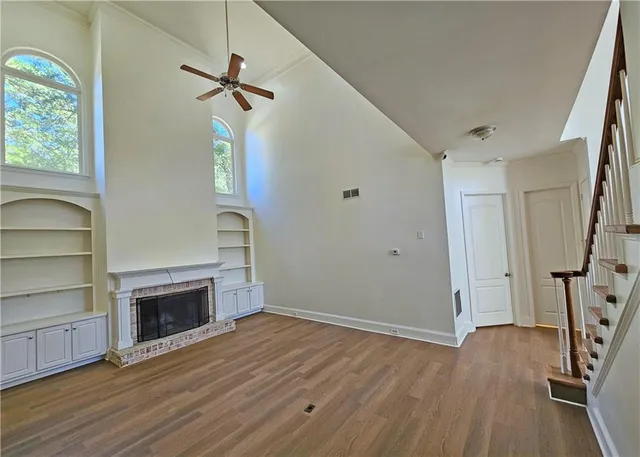 wooden floor fireplace and natural light in room