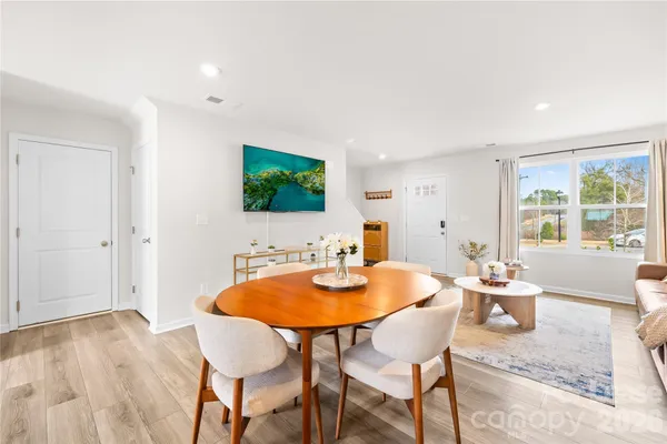 a dining room with furniture and window