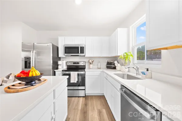 a kitchen with stainless steel appliances a microwave sink stove and refrigerator