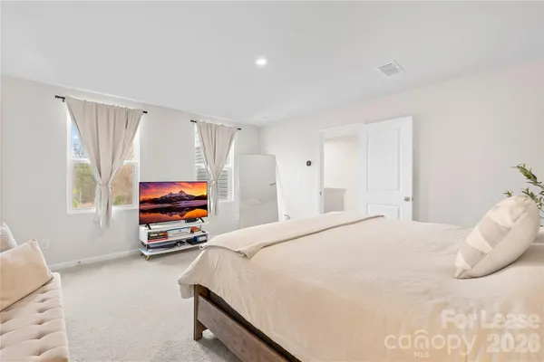 a bedroom with furniture and a window