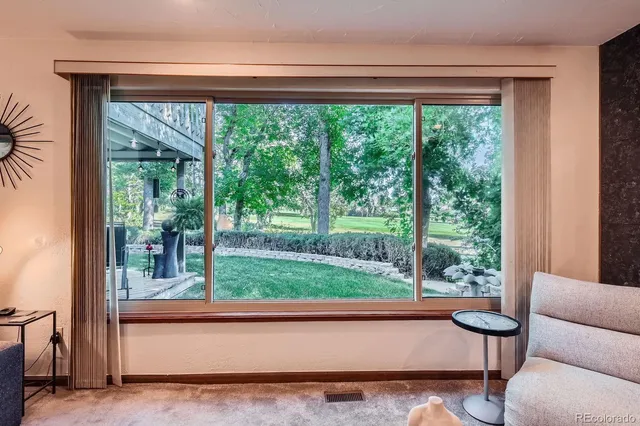 a living room with a large window and a floor to ceiling window