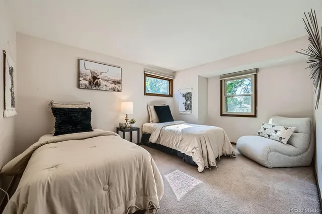 a spacious bedroom with two beds and a couch