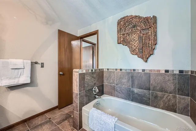 a bathroom with a tub and shower