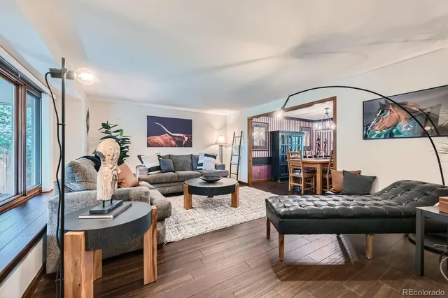 a living room with furniture and wooden floor