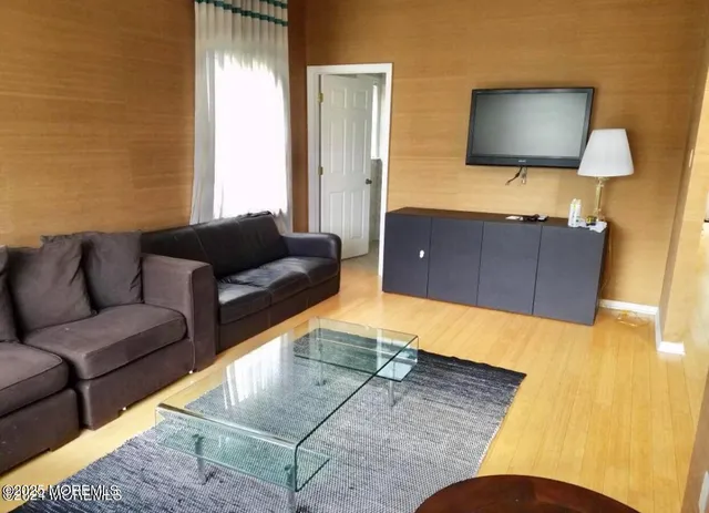 a living room with couches and a flat screen tv