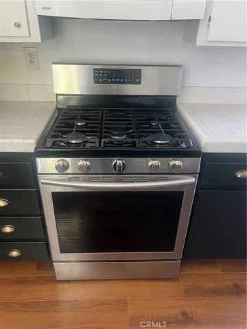 a stove top oven sitting inside of a kitchen