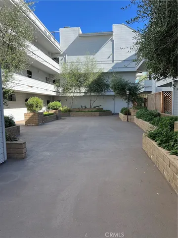 a view of a patio with table and chairs under an umbrella