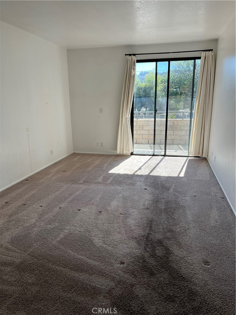 13331 Moorpark Street, Unit 110 Sherman Oaks, CA 91423 - Photo 22 of 32 a view of an empty room with a sliding door