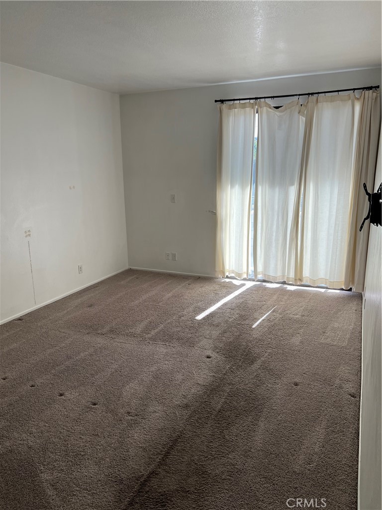 13331 Moorpark Street, Unit 110 Sherman Oaks, CA 91423 - Photo 23 of 32 a view of empty room with floor to ceiling window
