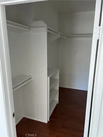 a view of walk in closet with empty racks