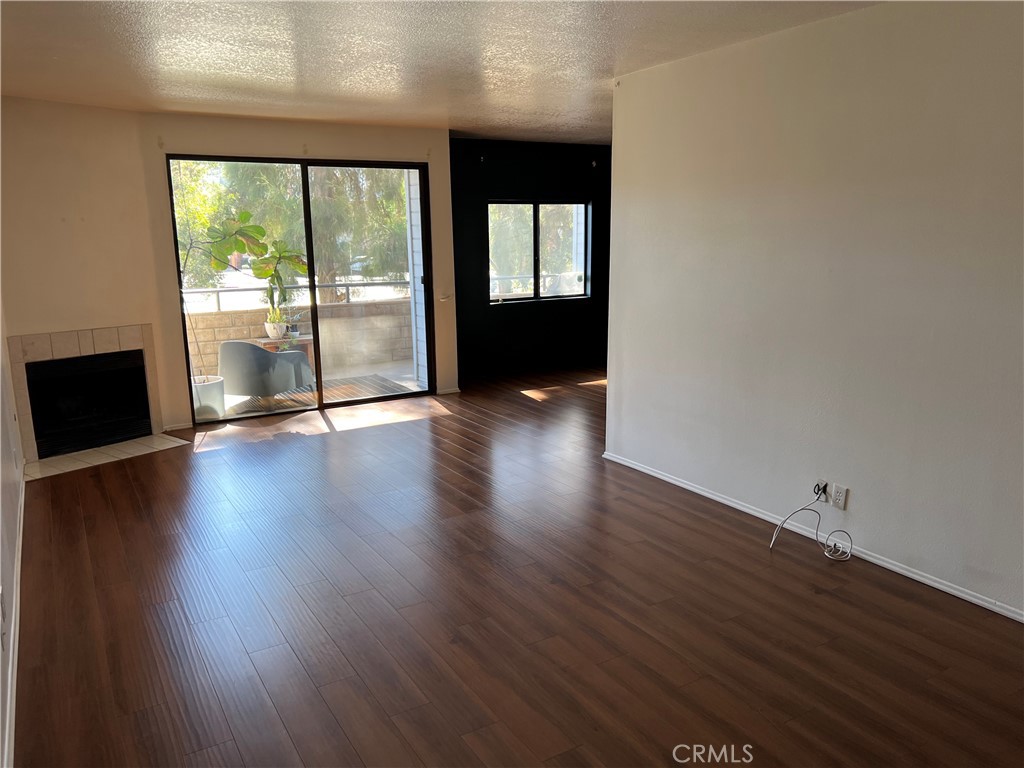 13331 Moorpark Street, Unit 110 Sherman Oaks, CA 91423 - Photo 3 of 32 an empty room with wooden floor and windows