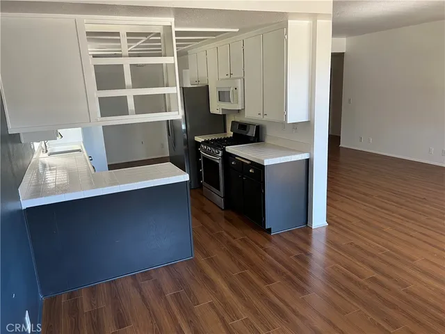 a kitchen with wooden cabinets and a stove top oven