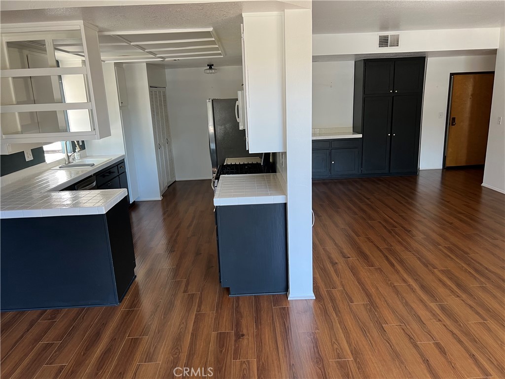 13331 Moorpark Street, Unit 110 Sherman Oaks, CA 91423 - Photo 5 of 32 a hallway view with furniture and wooden floor