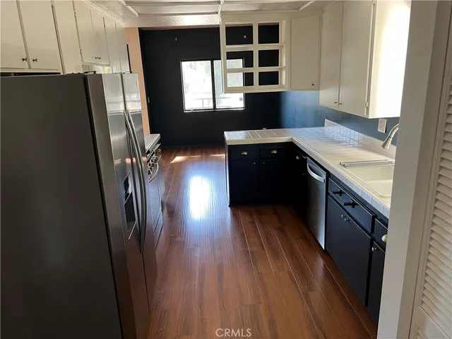 a kitchen with stainless steel appliances a refrigerator and a sink