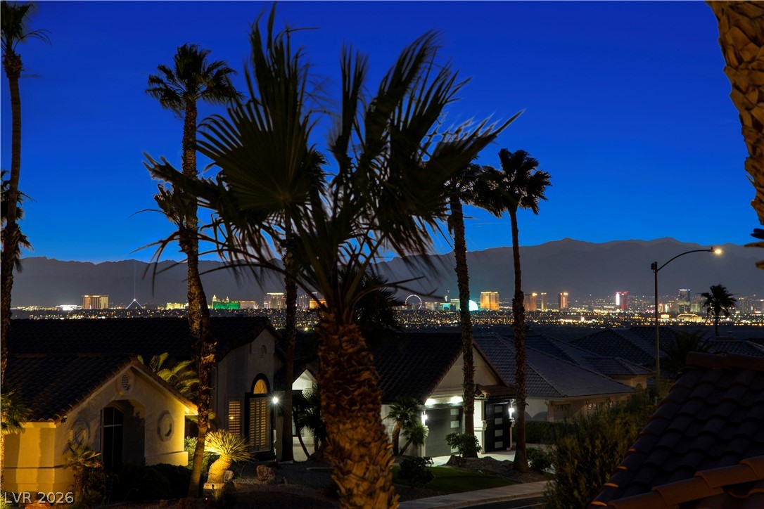 1135 Calico Ridge Drive Henderson, NV 89011 - Photo 79 of 86 Here are the views from the balcony. Capture the glittering city lights from this elevated property, framed by graceful palm trees and distant mountains.