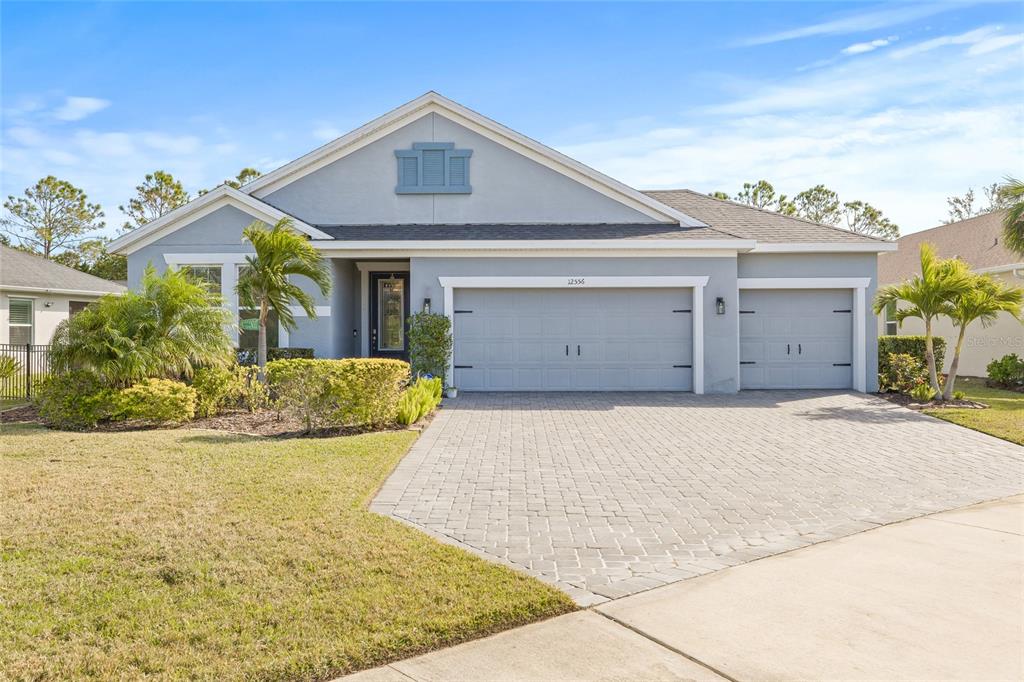 12556 Ryegrass Loop Parrish, FL 34219 - Photo 1 of 49 a front view of a house with a yard and garage