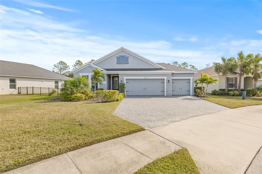12556 Ryegrass Loop Parrish, FL 34219 - Photo 3 of 49 a front view of a house with a yard and potted plants