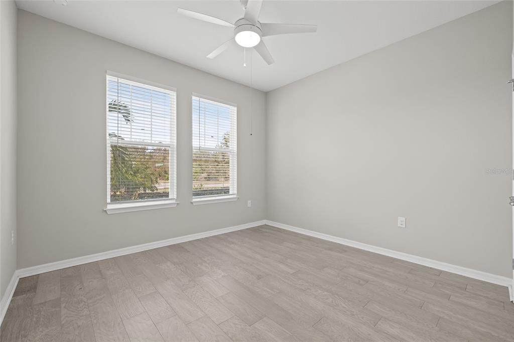 12556 Ryegrass Loop Parrish, FL 34219 - Photo 33 of 49 wooden floor in an empty room with a window