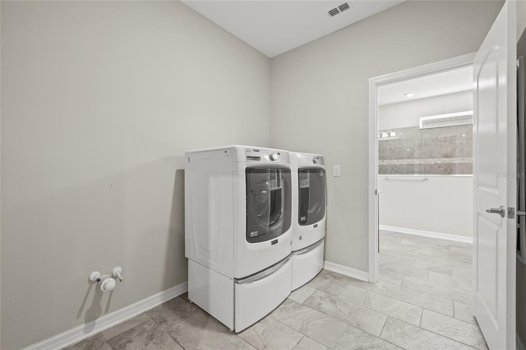 12556 Ryegrass Loop Parrish, FL 34219 - Photo 44 of 49 a utility room with dryer and washer