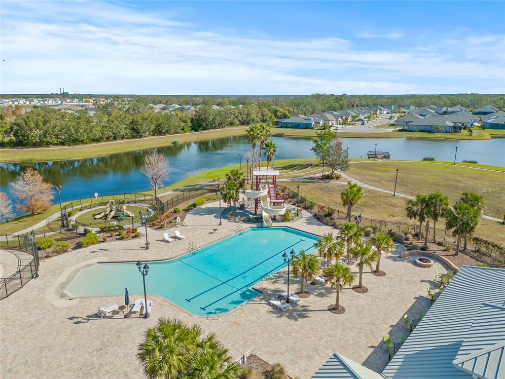 12556 Ryegrass Loop Parrish, FL 34219 - Photo 49 of 49 a view of a lake with a table and chairs