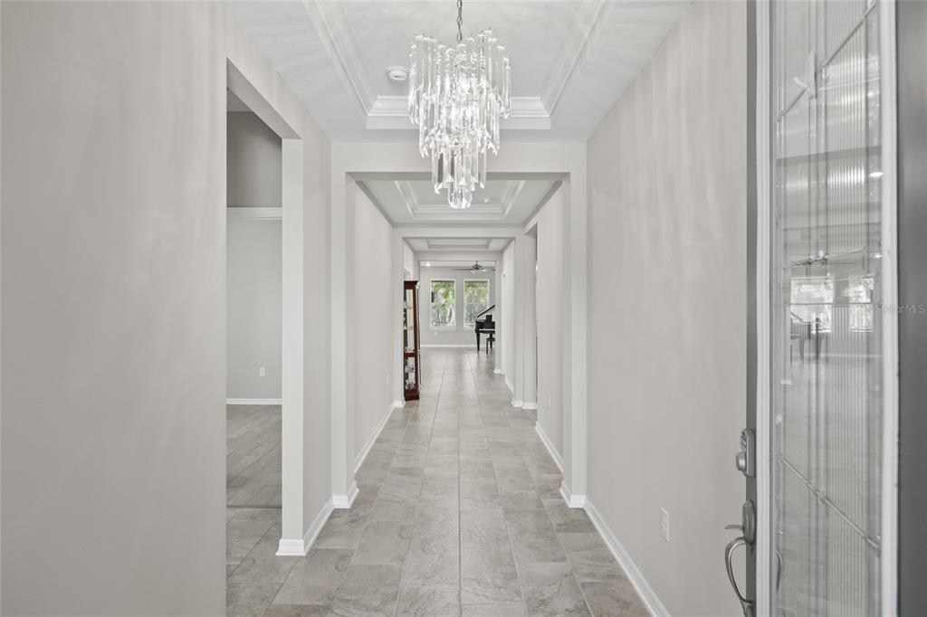12556 Ryegrass Loop Parrish, FL 34219 - Photo 7 of 49 a view of a chandelier in a hallway