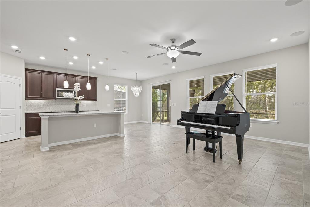 12556 Ryegrass Loop Parrish, FL 34219 - Photo 10 of 49 a kitchen with stainless steel appliances kitchen island hardwood floor sink and stove