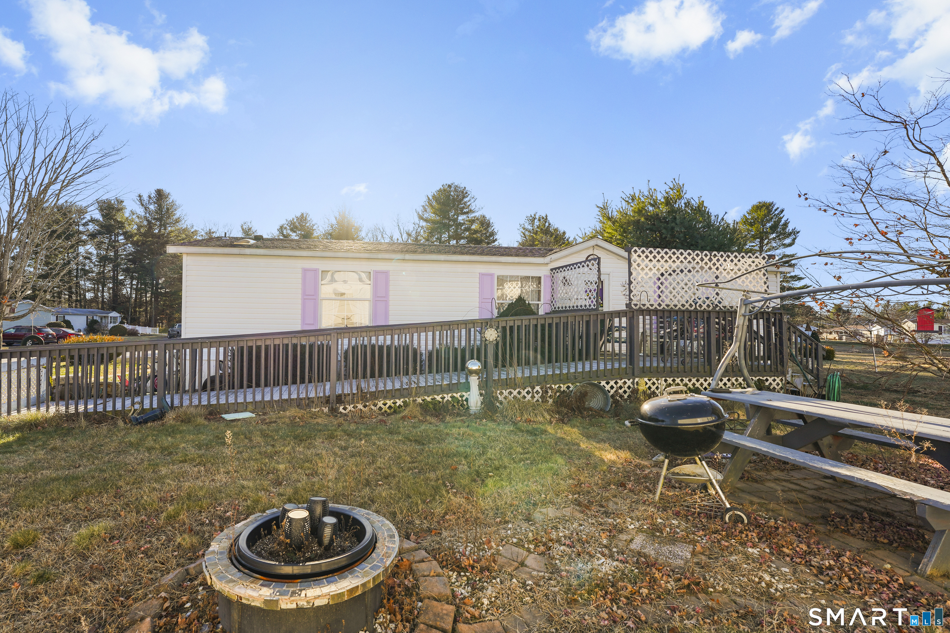 7 Jessie Lane Windham, CT 06256 - Photo 29 of 34 a backyard of a house with barbeque oven and outdoor seating