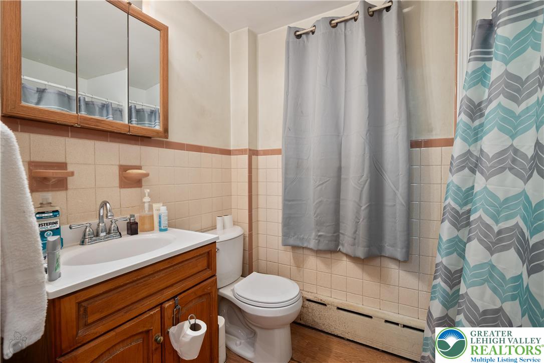 2401 Birch Street Wilson, PA 18042 - Photo 14 of 37 a bathroom with a sink a toilet and shower curtain