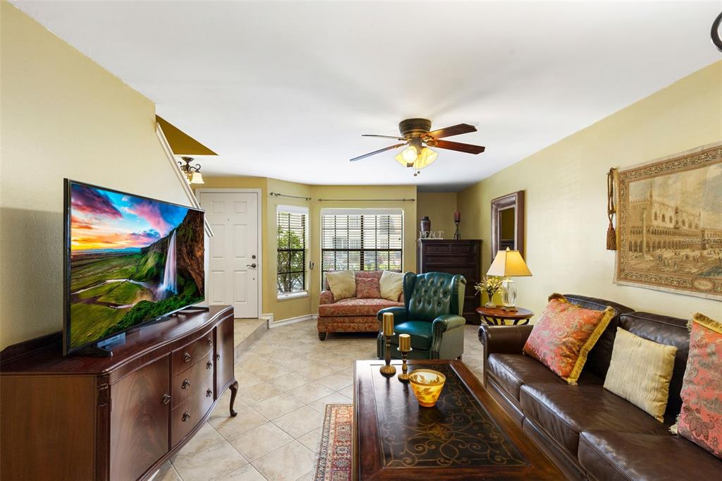 5100 Burchette Road, Unit 2701 Tampa, FL 33647 - Photo 7 of 38 a living room with furniture and a flat screen tv