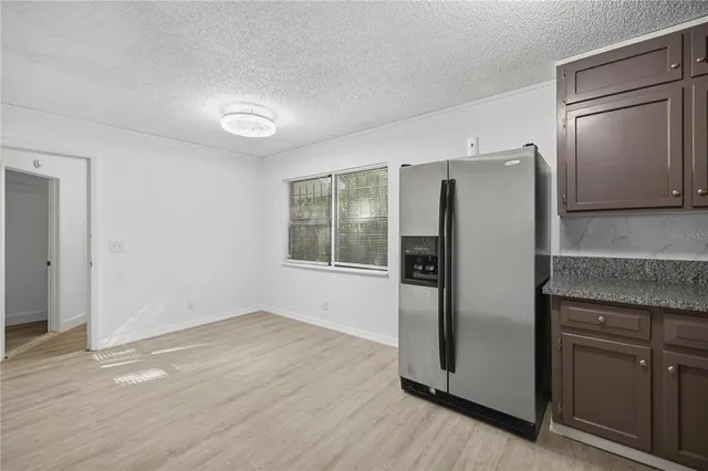 an empty room with wooden floor and a window